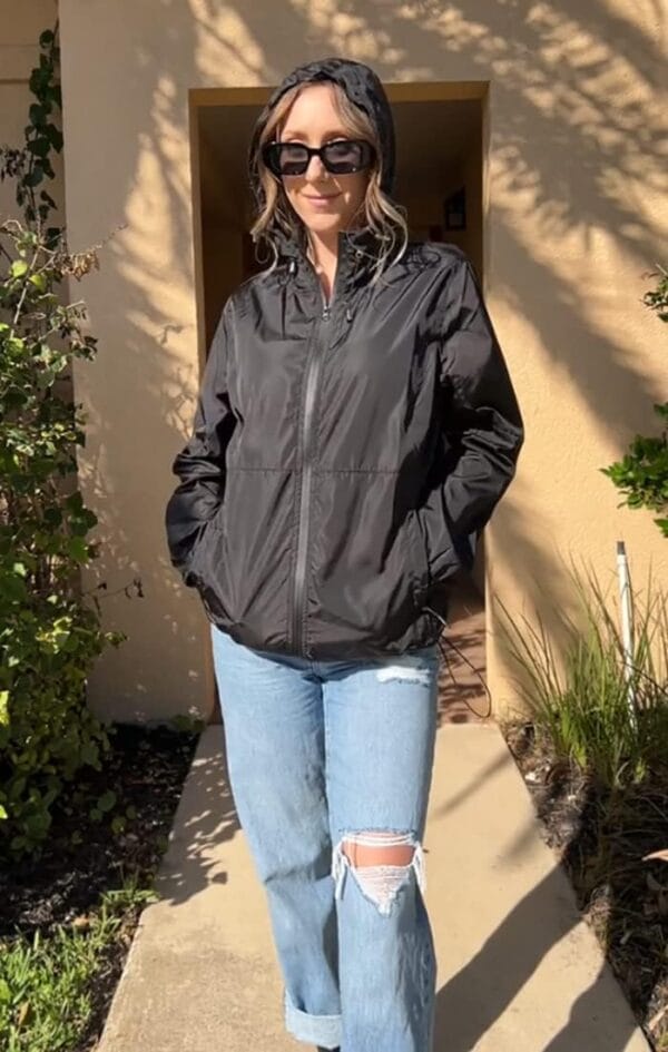 Women's lightweight portable rain jacket in bright blue, front view