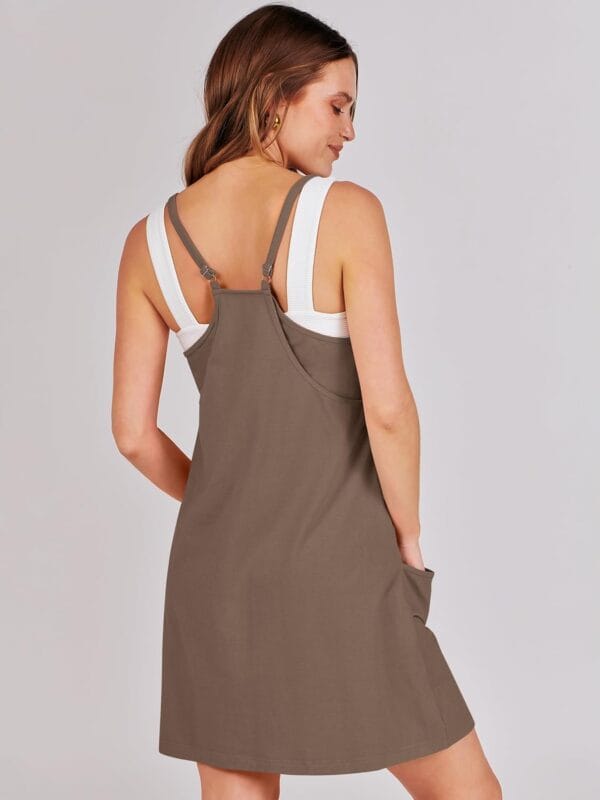 Women's summer tennis dress with built-in shorts, athletic fit, side view